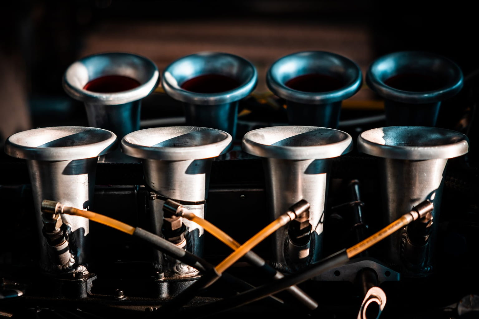 Close-up of an engine intake with fuel lines running between the intake runners