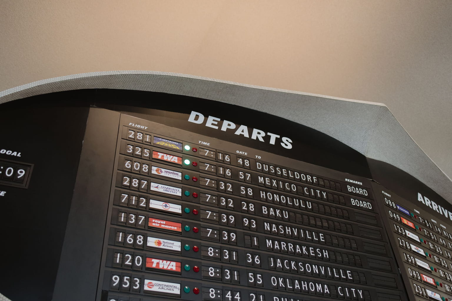 Airport departures board listing flight numbers, times and destinations
